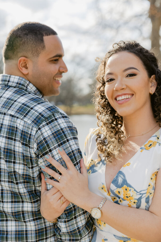Man and women holding arms in park in Spring Lake New Jersey for engagement session photos by Simone Jaramillo Photography