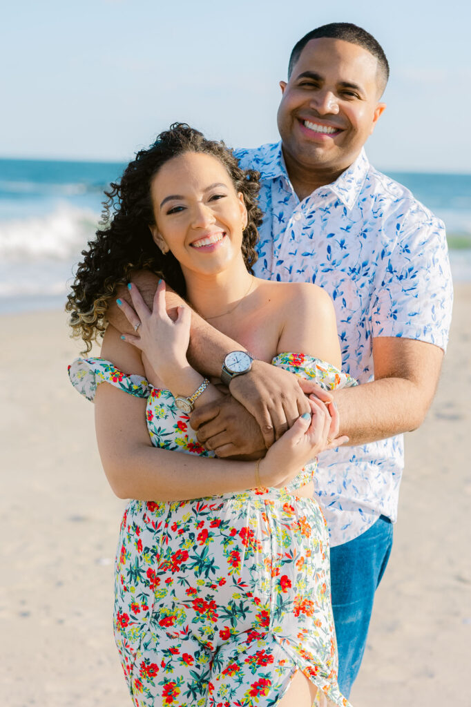 Man and women share embrace on a beach in Spring Lake Beach, New Jersey.  Photo taken by Simone Jaramillo Photography