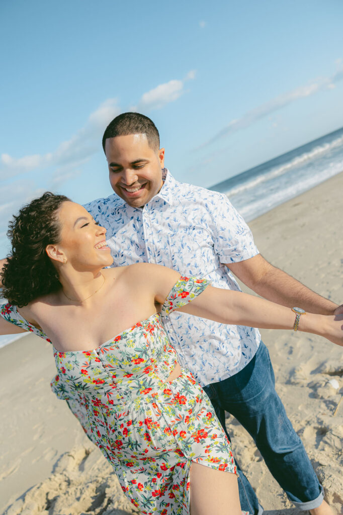 Man and women share embrace on a beach in Spring Lake Beach, New Jersey.  Photo taken by Simone Jaramillo Photography