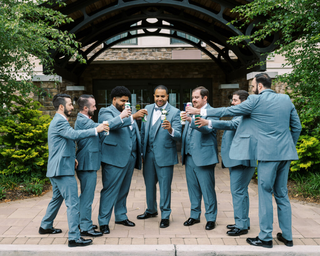 groom and groomsmen toasting to a summer wedding in new jersey