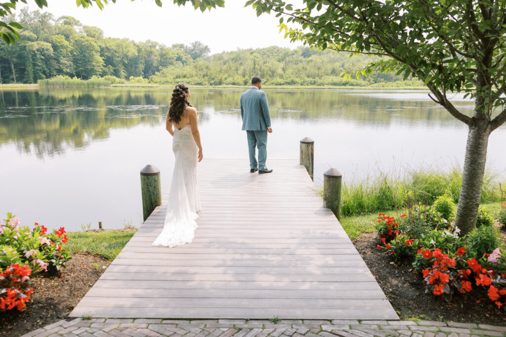 Couple's first look by the water at their The Mill Lakeside Manor wedding