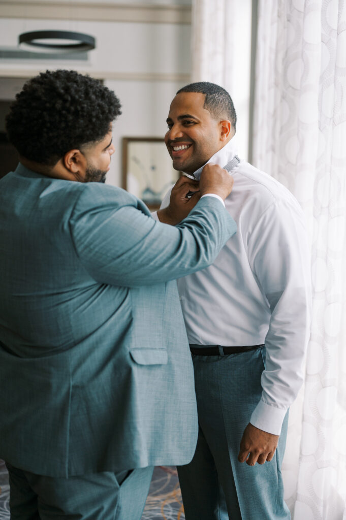 groom getting ready with groomsman