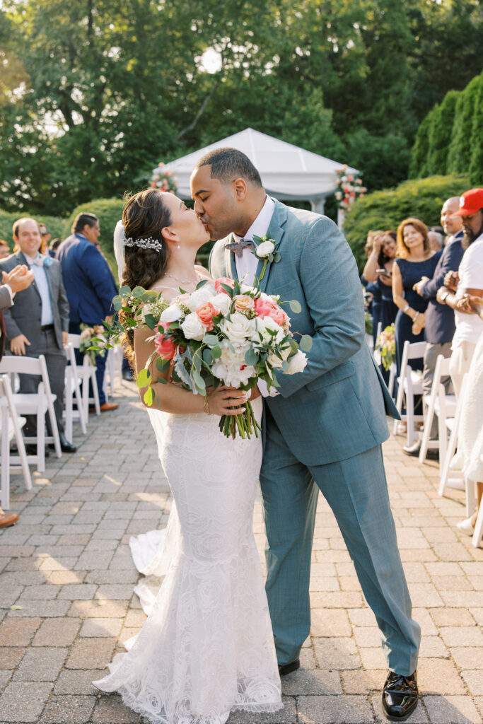 bride and groom kissing after their wedding ceremony