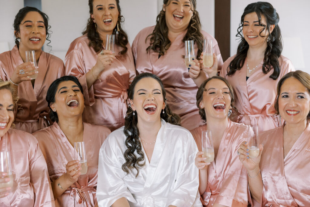 bridal party getting ready with matching robes at for a mill lake wedding in spring lake new jersey
