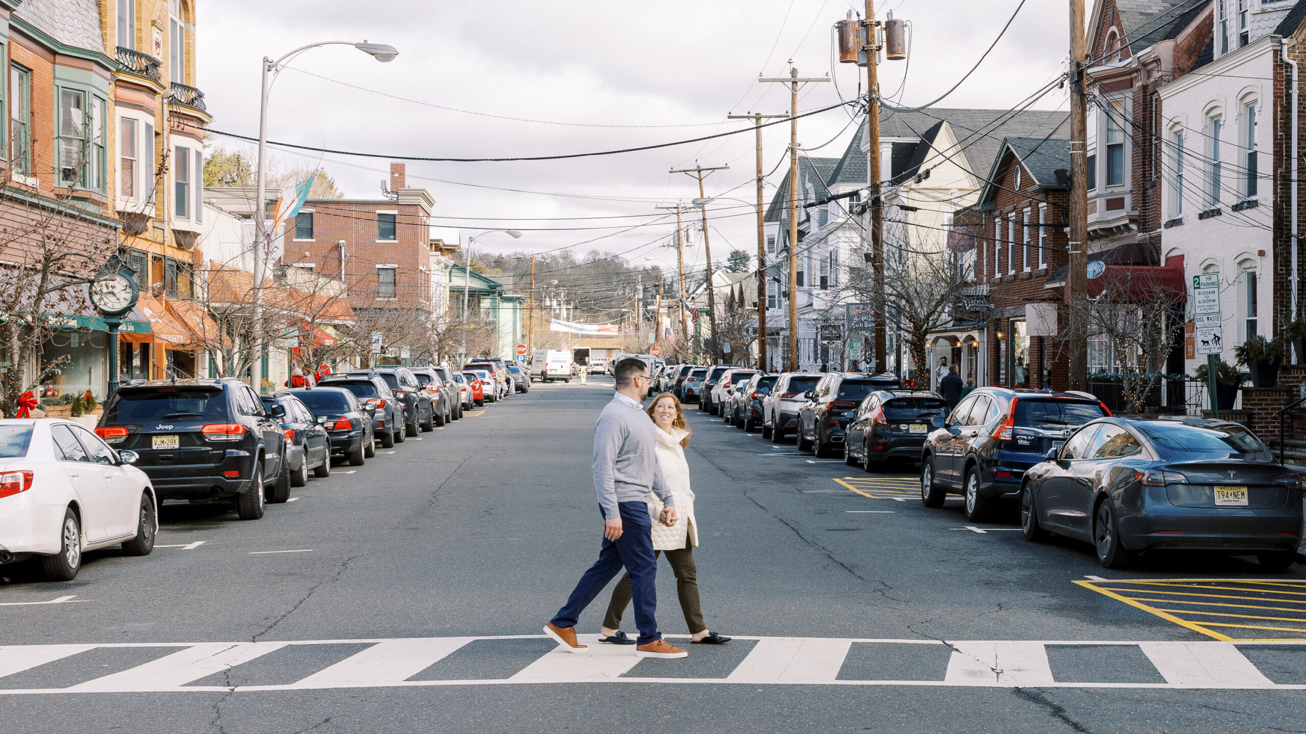 Engaged couple walking in downtown Clinton New Jersey for a engagement session.