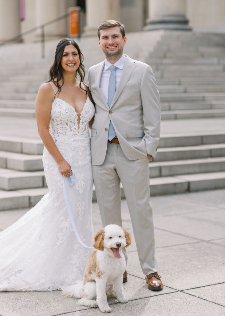 bride and groom with puppy front of baltimore museum