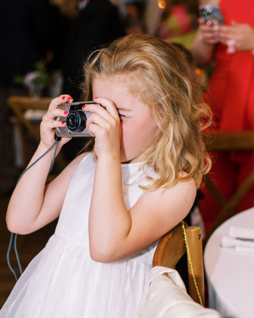 Flower girl taking photos