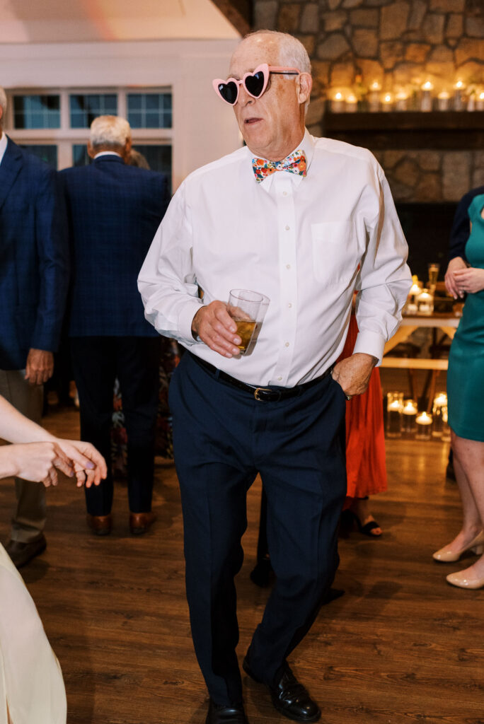 Heart glasses on wedding guest during reception