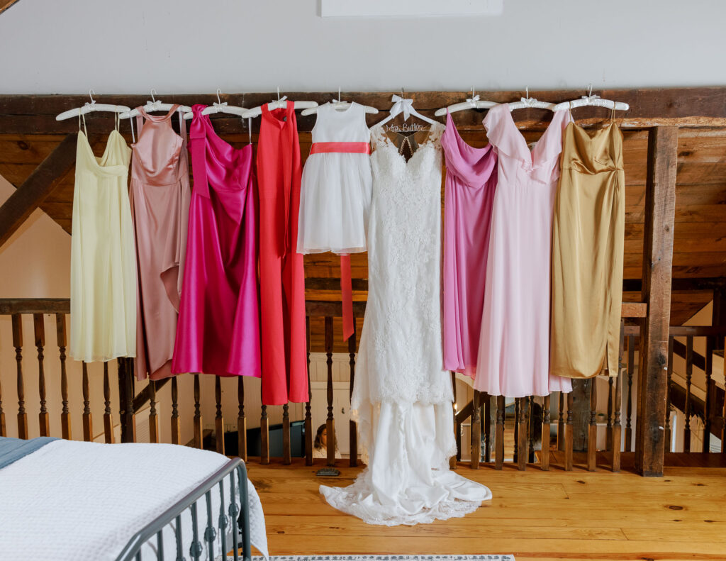 Bride dress with bridesmaids dresses hung up, spring bridal party dresses