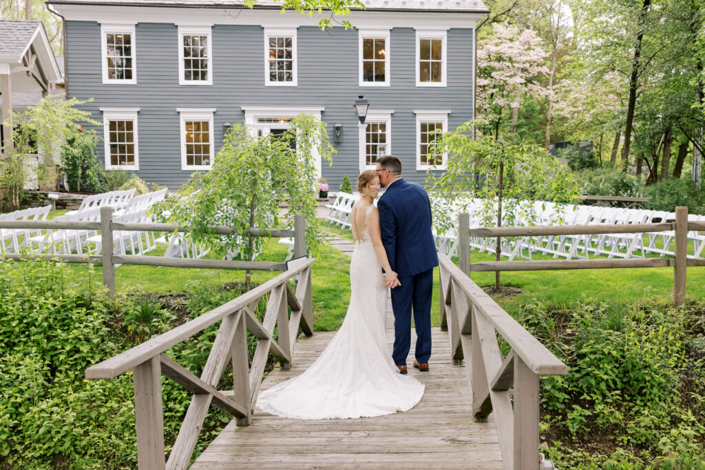 Bride and Groom on bridge, Milllrace Pond Wedding in the lawn area