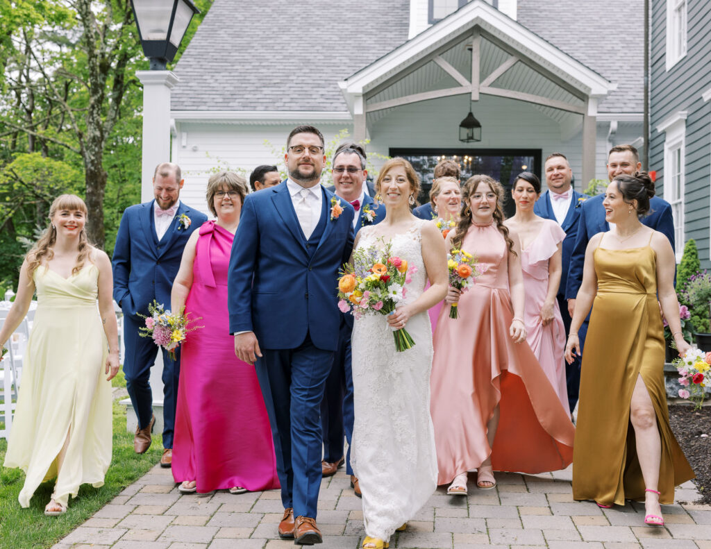 Couple walking with bridal party for new jersey spring wedding, garden spring bouquets and boutineers