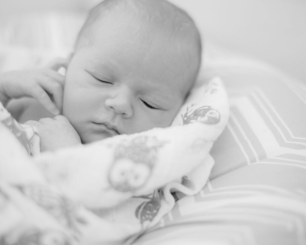 newborn wrapped in blanket for a newborn photography session