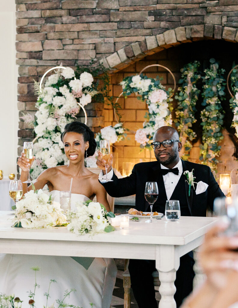 couple at sweetheart table during toast