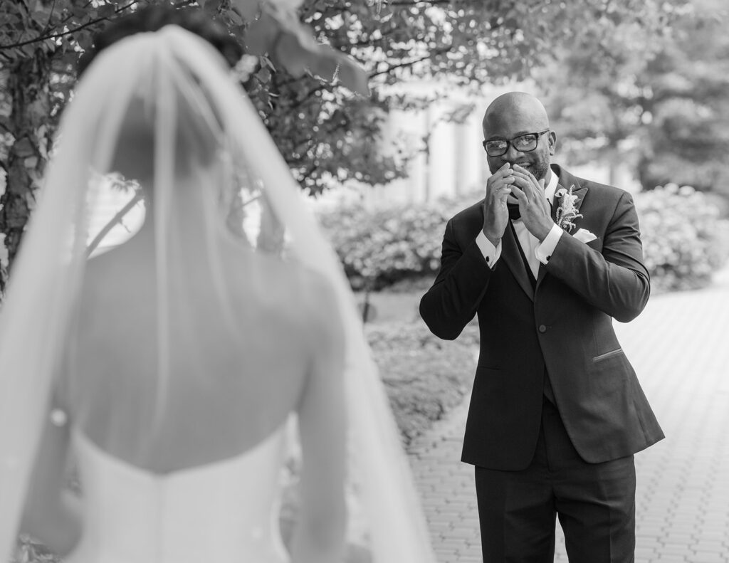 First Look with couple and groom surprised at Ryland Inn, New Jersey with photos by Simone Jaramillo Photography