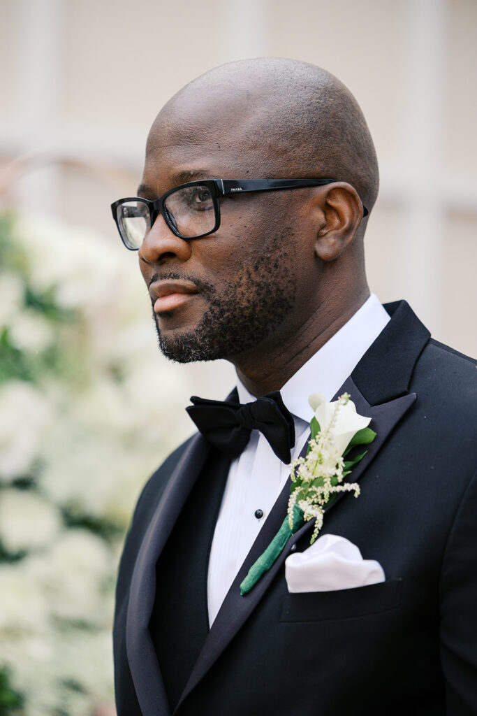 Groom in black bow tie suit and white handkerchief 