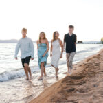 Family of four walking on Nevada Beach during sunset for a photo session with Simone Jaramillo Photography