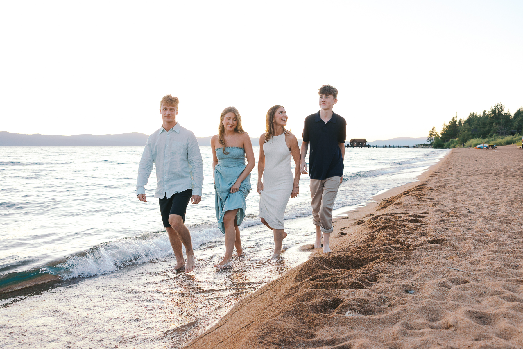 Family of four walking on Nevada Beach during sunset for a photo session with Simone Jaramillo Photography
