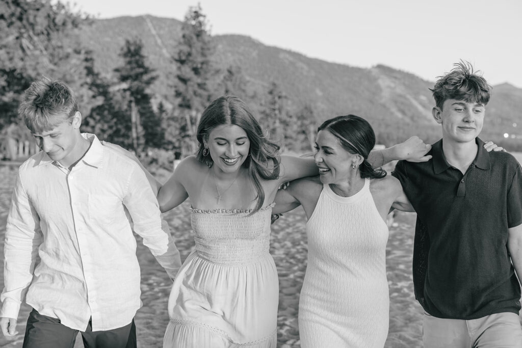 black and white photo of family walking along beach in Lake Tahoe