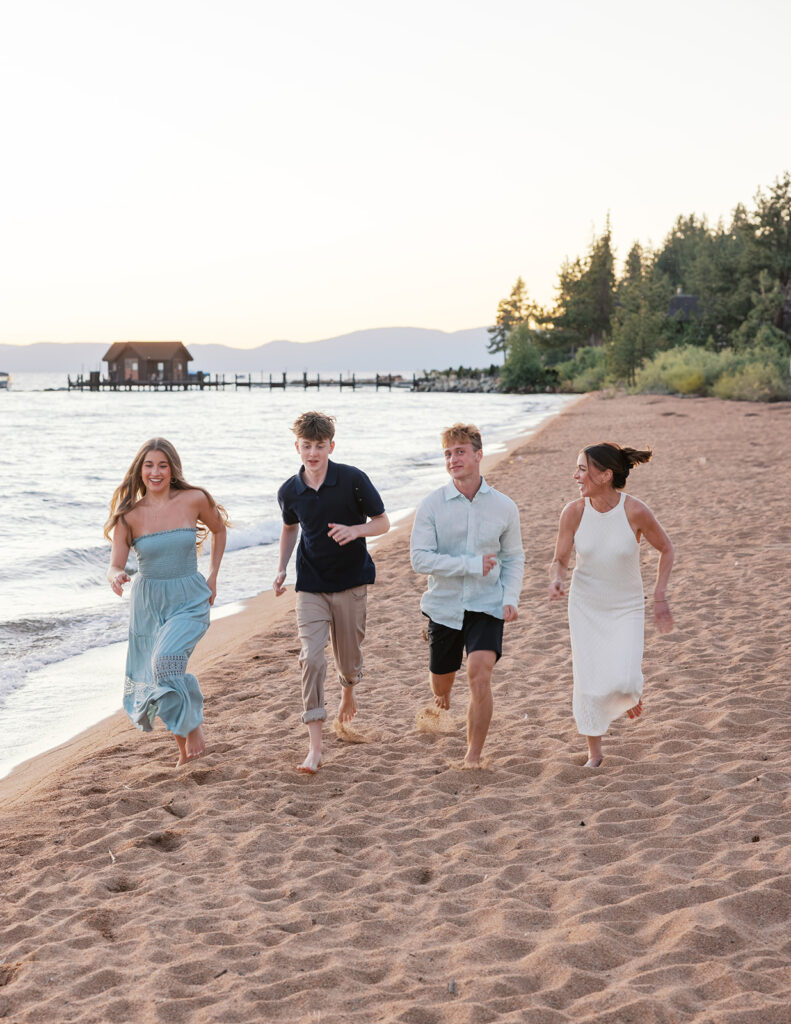 Family running on beach in lake tahoe