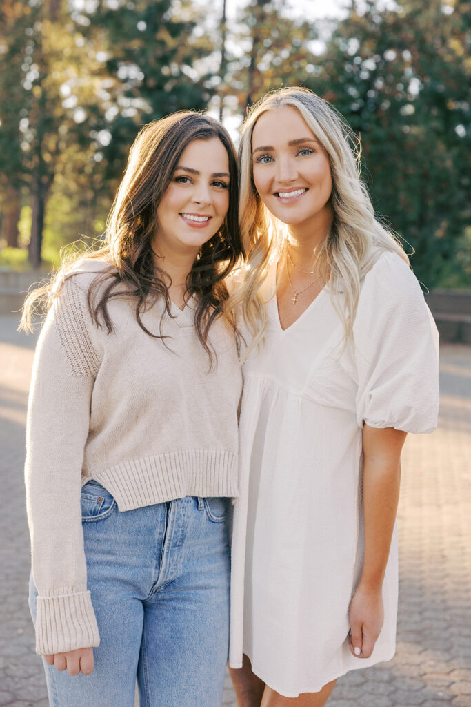siblings photo with light colored clothes with trees behind them
