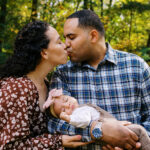 couple kissing during fall family session in the park with Simone Jaramillo Photography
