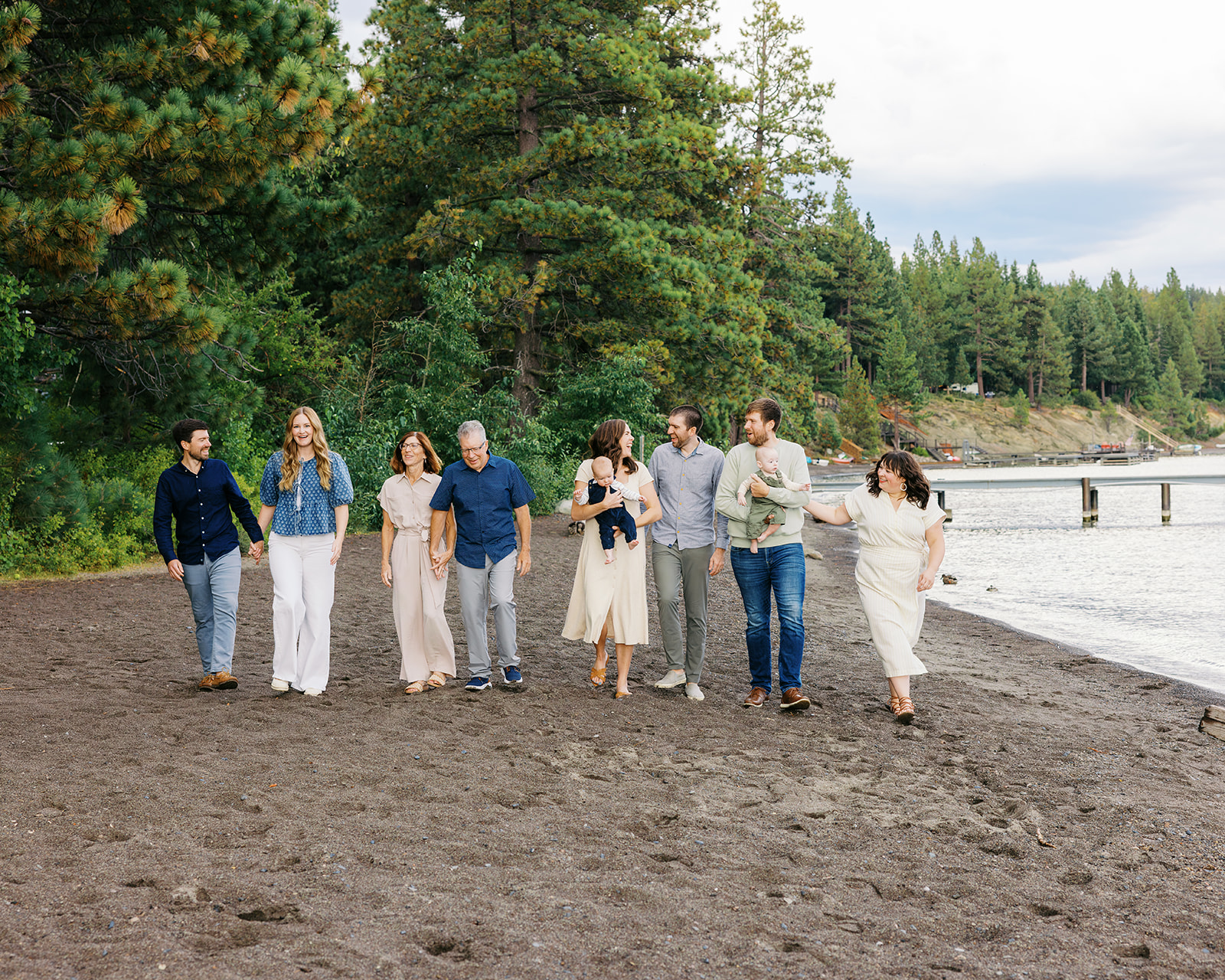Walking with family on the beach shore of Lake Tahoe, Ca for a family session. Photo taken by Simone Jaramillo Photography