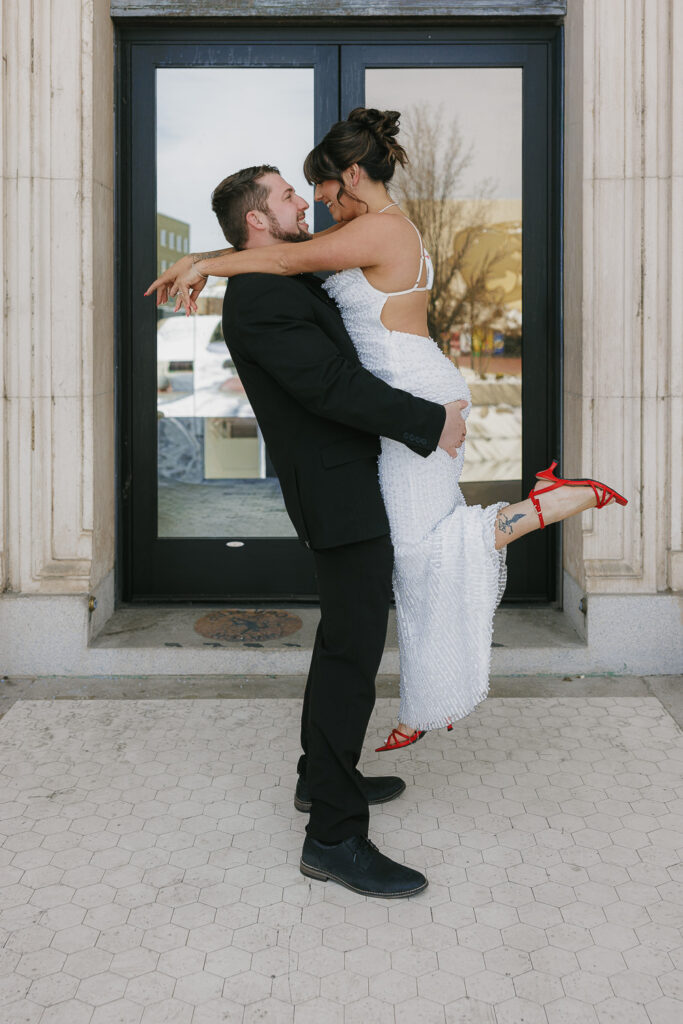 Man in black suit and women in white long gown, Downtown Reno Nevada,  Engagement photos with Simone Jaramillo Photography