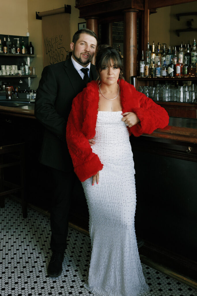 couple poses by bar indoors, film photographer in reno nevada